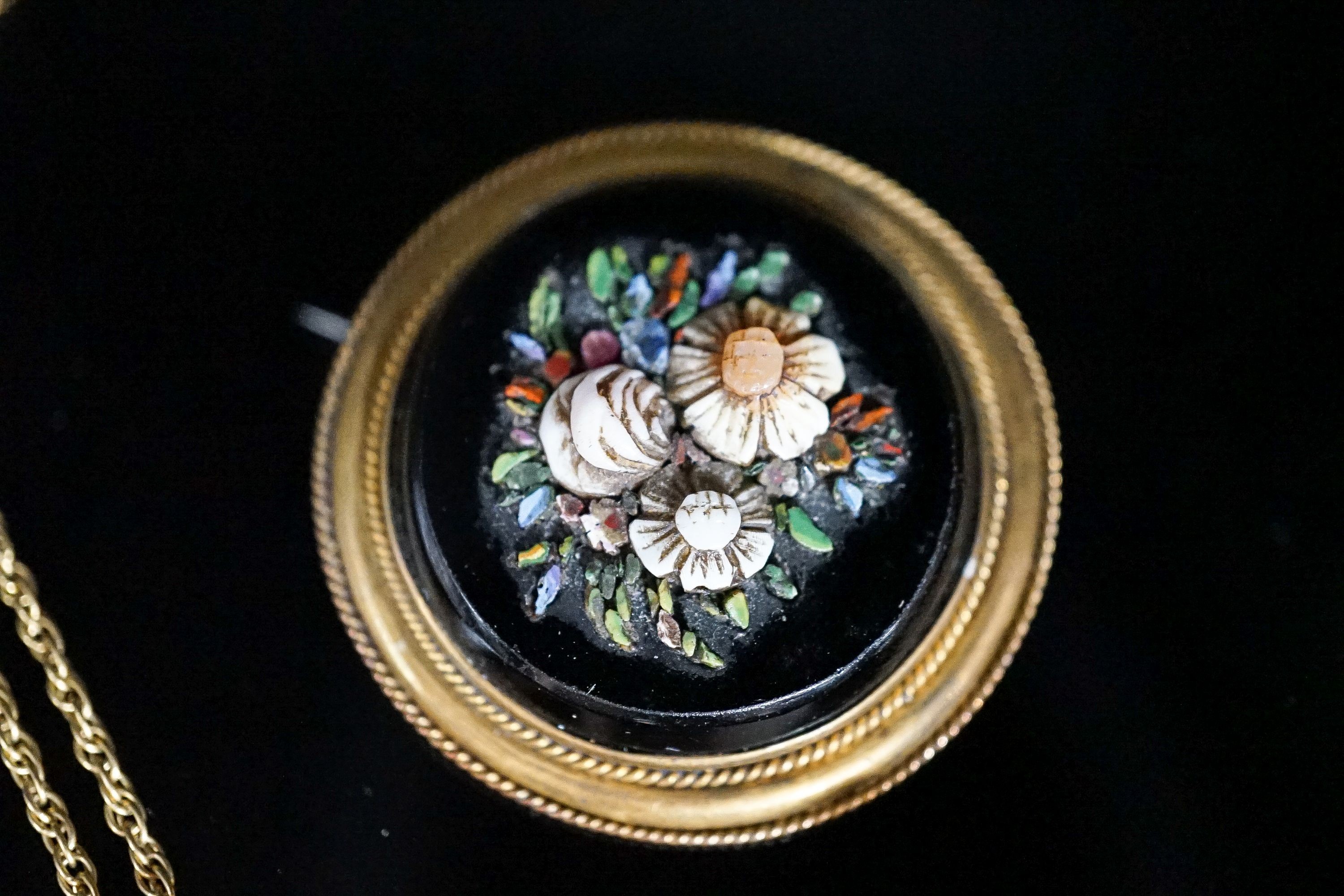 A Victorian yellow metal, black onyx and hardstone set circular brooch, 38mm, a yellow metal and coral bead brooch and a yellow metal and turquoise set pendant, on a 375 chain.